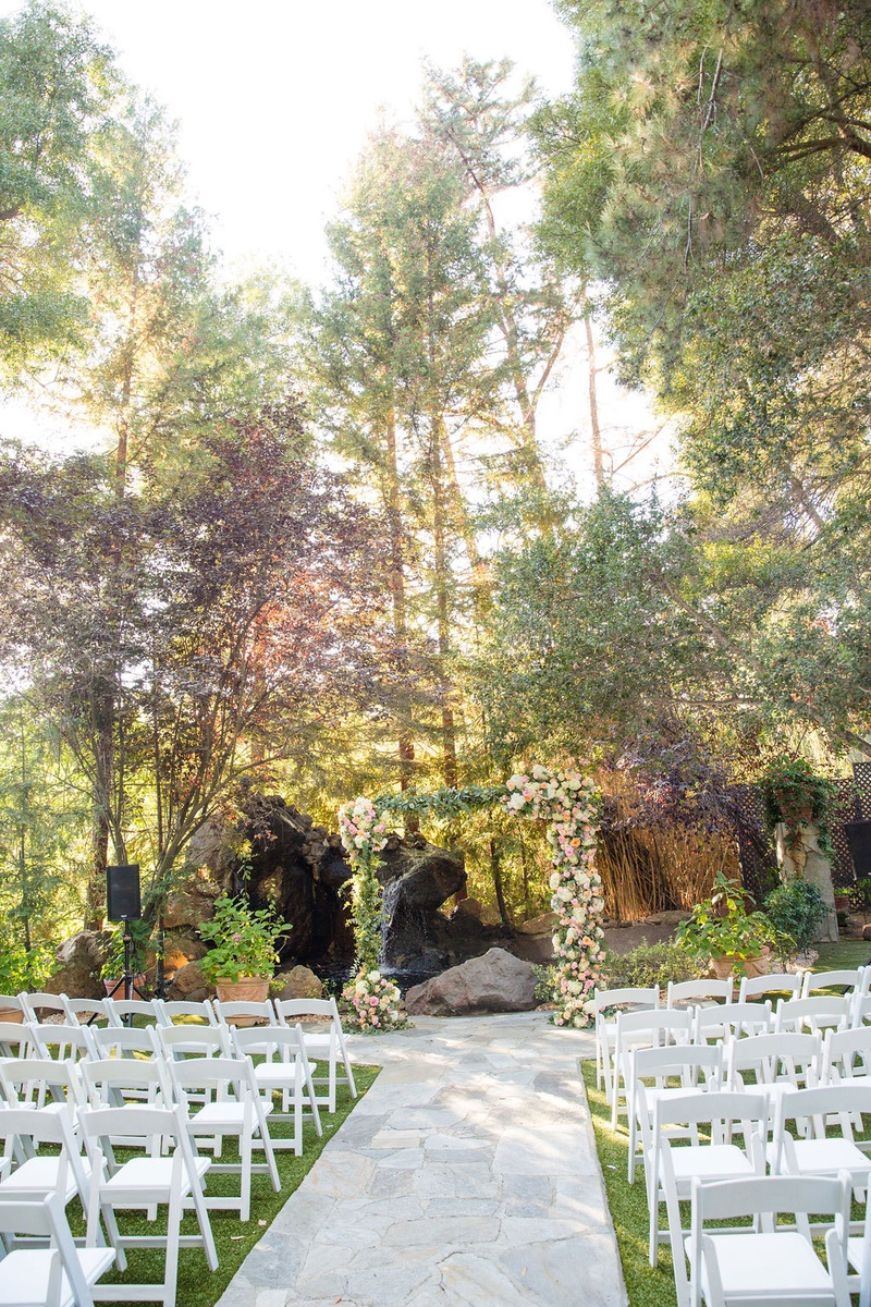 Outdoor Ceremony in Malibu
Photography: Ashley Paige Photography
Read More:
http://www.insideweddings.com/weddings/elegant-outdoor-fall-wedding-at-a-rustic-chic-venue-in-malibu/1244/ wedding ceremony stone aisle white chairs green lawn arch with fresh flowers tree backdrop