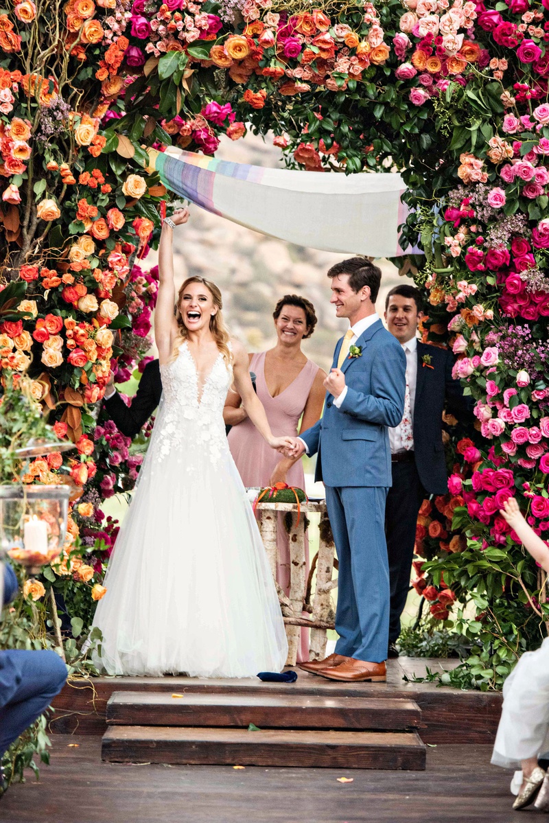 Colorful Bohemian Ceremony Décor
Photography: Laurie Bailey Photography
Read More:
http://www.insideweddings.com/weddings/outdoor-jewish-ceremony-reception-with-colorful-bohemian-decor/1330/ outdoor wedding ceremony wood aisle pink orange yellow purple red flower ceremony decor rainbow