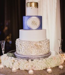 Blue, White %26 Gold Wedding Cake
Photography: Shaun Menary Photography
Read More:
http://www.insideweddings.com/weddings/multicultural-wedding-with-a-winter-wonderland-theme-in-dallas/1126/ White wedding cake blue layer gold layer with gold tip rosette texture on bottom tier