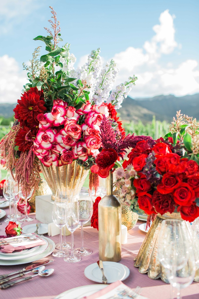 Bold Red and Dark Purple Floral Arrangements
Photography: Jenny Quicksall Photography
Read More:
http://www.insideweddings.com/weddings/romantic-wedding-shoot-for-valentines-day-at-california-vineyard/751/ red and dark purple flower floral arrangements in gold vases with pink table linens vineyard setting
