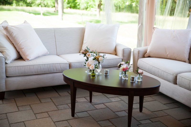 Alfresco Lounge Area with Plush Pillows
Photography: Michael Bambino %26 Co.
Read More:
http://www.insideweddings.com/weddings/whimsical-open-air-secret-garden-wedding-with-soft-spring-hues/777/ comfortable lounge area with white couches and simplistic detailing in outside tented space
