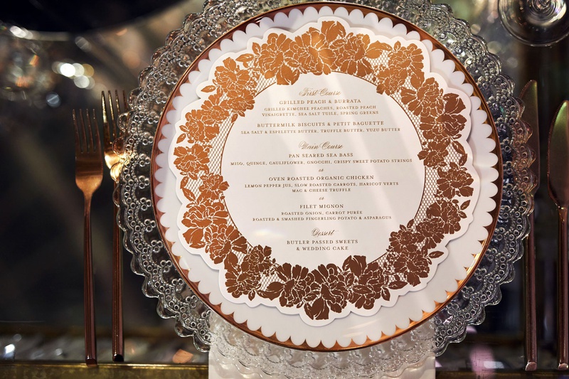 Rose Motif Wedding Menu on Plate
Photography: Christian Oth Studio
Read More:
http://www.insideweddings.com/weddings/traditional-cathedral-wedding-luxury-reception-in-new-york-city/1331/ wedding reception clear charger plate with gold copper rose menu design circle motif flatware