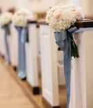 White Hydrangea %26 Pink Rose Pew Décor
Photography: Karlisch Studio
Read More:
http://www.insideweddings.com/weddings/classic-ceremony-at-smu-chapel-ballroom-reception-in-dallas/731/ Wedding ceremony church pews decorated with white hydrangeas, pink roses, and blue ribbon