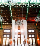 Rustic-Elegant Ceremony Space
Photography: Artistrie Co.
Read More:
http://www.insideweddings.com/weddings/rustic-elegant-celebration-with-personalized-elements-in-chicago/1026/ Wedding ceremony in historic building with tall drapery crystal chandeliers wood brick elements