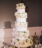 Tall Cake with White Rose Layers
Photography: Harwell Photography
Read More:
http://www.insideweddings.com/weddings/traditional-church-ceremony-luxury-ballroom-reception-in-atlanta/1096/ Tall white wedding cake round tiers with layers of roses ivory in between garden rose candles