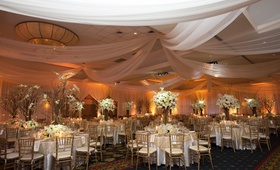 Ballroom Wedding Reception
Photography: Justin Marantz
Read More:
http://www.insideweddings.com/weddings/unforgettable-miami-wedding-with-acrobats-tiger-cubs-fireworks/437/ White fabric draped from ceiling over wedding tables