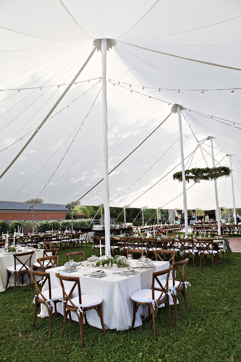 Tented Reception on Farm
Photography: Stacy Newgent
Read More:
http://www.insideweddings.com/weddings/rustic-barn-wedding-tented-reception-on-family-farm-in-ohio/690/ Farm wedding reception on grassy area with white open-sided tent, rustic chairs, white tablecloths
