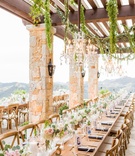 Greenery and Chandelier Over Wood Table
Photography: Love %26 You Studios
Read More:
http://www.insideweddings.com/weddings/destination-wedding-with-unique-personalized-elements-in-malibu/1079/ Outdoor terrace wedding wood table no linens runner white pink flowers greenery cut out table number