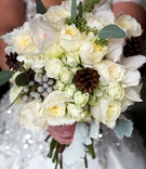Wintry Bridal Bouquet
Photography: Handeland Tesoro Photography
Read More:
http://www.insideweddings.com/weddings/snowy-outdoor-winter-ceremony-cozy-lodge-reception/522/ Bride carrying pinecones, leaves, and white flowers