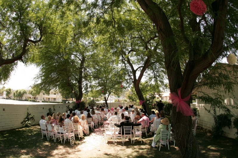 Outdoor Catholic Ceremony
Photography: Asgeir Bollason for David Michael Photography
Read More:
http://www.insideweddings.com/weddings/pink-green-memorial-day-weekend-wedding-in-palm-desert/128/ Trees wrapped with tulle and white chairs