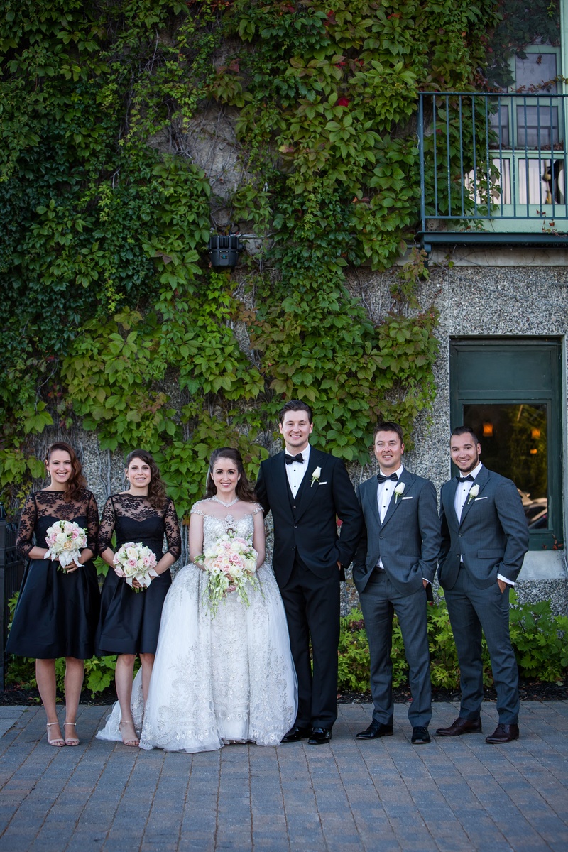 Bride %26 Groom with Bridesmaids in Black
Photography: Magnolia Studio
Read More:
http://www.insideweddings.com/weddings/charming-church-ceremony-romantic-ballroom-reception-in-quebec/1075/ Bride in kleinfeld bridal beaded ball gown with bridesmaids in lace cocktail dresses three quarter