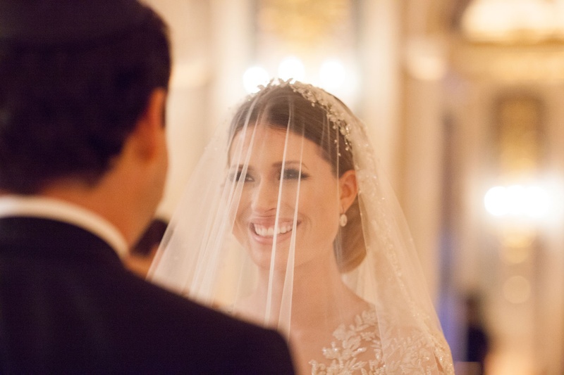Bride Smiling Beneath Veil at Ceremony
Photography: Ira Lippke Studios
Read More:
http://www.insideweddings.com/weddings/opulent-destination-wedding-at-a-luxury-hotel-in-new-york-city/1004/ Bride looking into groom's eyes during wedding ceremony long sleeve dress with illusion details veil