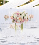 Shades of Pink and White Centerpiece
Photography: Brian Leahy Photography
Read More:
http://www.insideweddings.com/weddings/alfresco-ceremony-with-sweeping-ocean-views-tented-reception/1112/ wedding reception all white space with floral centerpiece with shades of white and pink