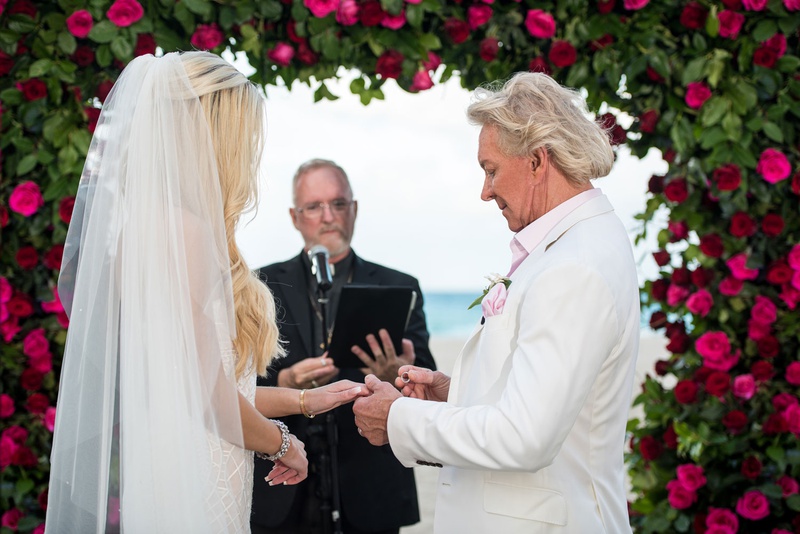 Groom Putting Wedding Ring on Bride
Photography: Suzanne Delawar Studios
Read More:
http://www.insideweddings.com/weddings/intimate-oceanfront-wedding-with-romantic-red-pink-white-palette/1235/ bride with long blonde hair and veil groom in white jacket pink shirt putting ring on bride's finger