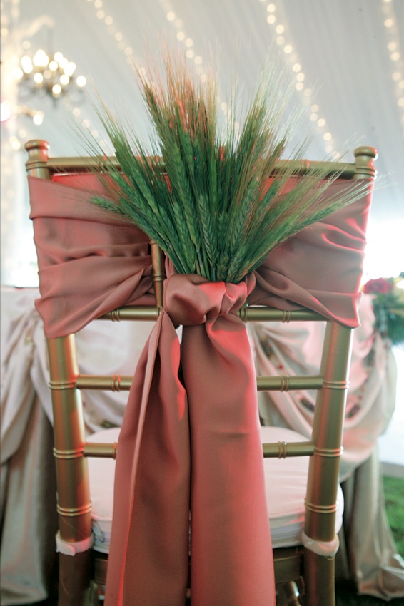 Bride and Groom Chairs
Photography: Mark Staff Photography
Read More:
http://www.insideweddings.com/weddings/autumn-inspired-golf-club-wedding-in-south-carolina/149/ Gold chair tied with red sash and dried green barley and wheat