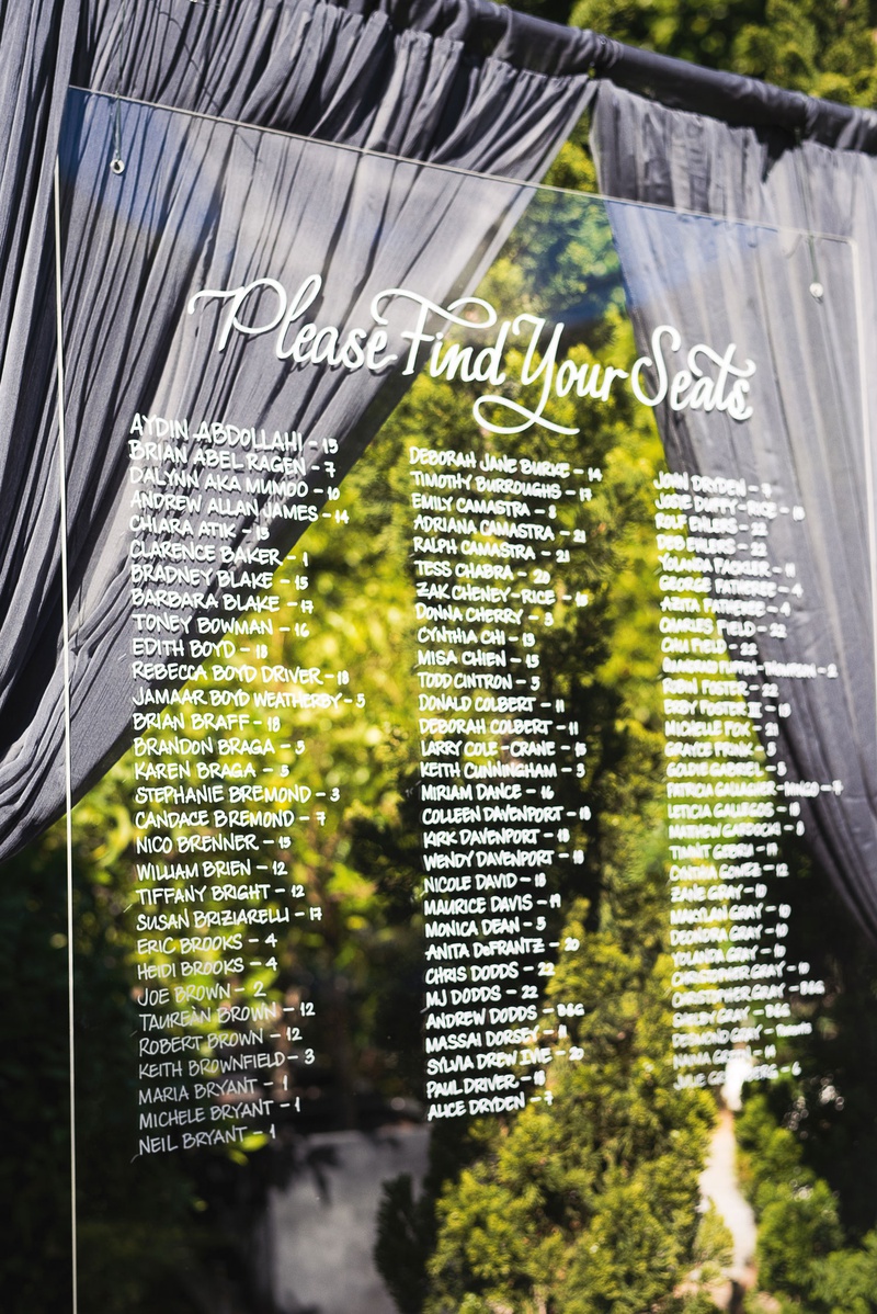 Acrylic Seating Chart with Drapery
Photography: Callaway Gable
Read More:
http://www.insideweddings.com/weddings/modern-in-the-round-ceremony-whimsical-garden-inspired-reception/1155/ Wedding reception outdoor cocktail hour acrylic lucite seating chart please find your seats