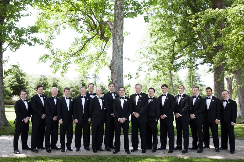 Groom and Groomsmen Outside in Ohio
Photography: Michael Bambino %26 Co.
Read More:
http://www.insideweddings.com/weddings/whimsical-open-air-secret-garden-wedding-with-soft-spring-hues/777/ a groom and his groomsmen wearing black tuxedos stand in an open-air area