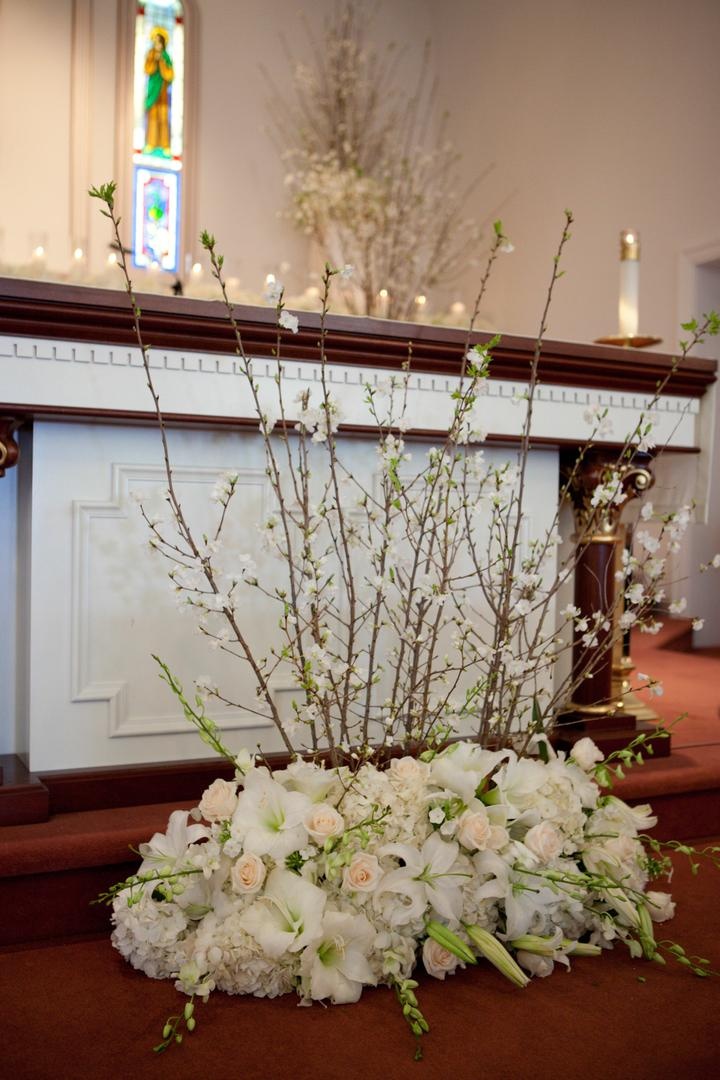 Altar Decor
Photography: Josh Lynn Photography
Read More:
http://www.insideweddings.com/weddings/purple-white-gold-new-jersey-celebration/339/ Altar decorated with light colored flowers and cherry blossom branches for a wedding