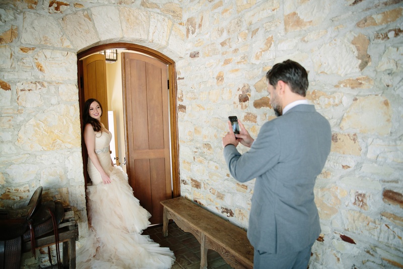 Groom Takes Photo of Bride
Photography: Karlisch Photography
Read More:
http://www.insideweddings.com/weddings/modern-rustic-wedding-full-of-flowers-and-geometric-details/906/ groom in grey suit takes photo on his phone of the bride in a ruffled blush wedding dress
