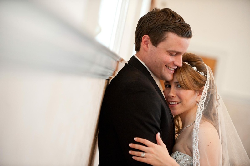 Bride and Groom
Photography: Josh Lynn Photography
Read More:
http://www.insideweddings.com/weddings/purple-white-gold-new-jersey-celebration/339/ Bride in a veil with a decorative trip and groom in a black tuxedo