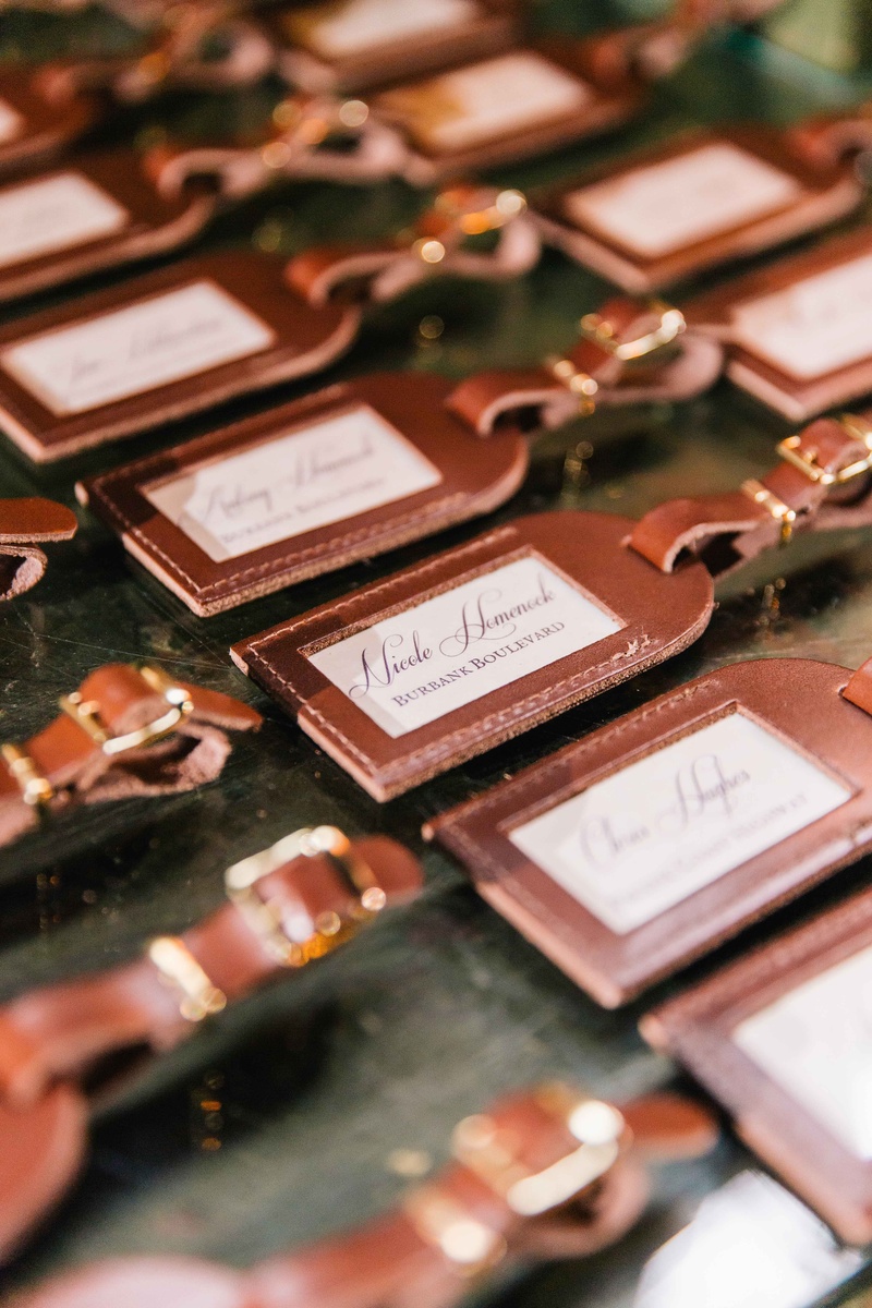 Embossed Luggage Tag Escort Cards
Photography: Vue Photography
Read More:
http://www.insideweddings.com/weddings/baroque-autumn-wedding-with-deep-wine-tones-in-north-carolina/770/ embossed leather luggage tags in calligraphy as escort cards and favors