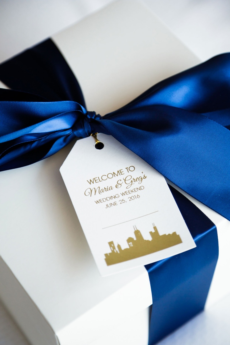 Weekend Welcome Box with Ribbon
Photography: Bob %26 Dawn Davis Photography
Read More:
http://www.insideweddings.com/weddings/church-ceremony-colorful-tented-reception-at-a-private-residence/1025/ Welcome box gift for guests dark blue ribbon with personalized tag skyline