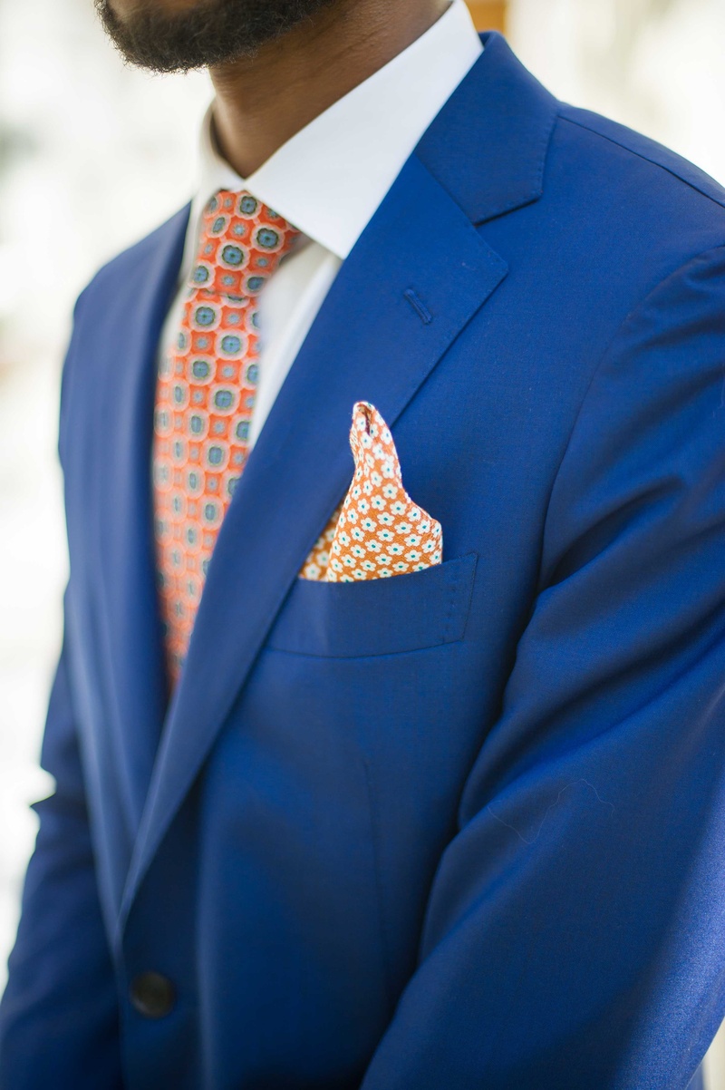 Groom's Blue Tuxedo, Orange %26 Blue Details
Photography: Eli Turner Studios
Read More:
http://www.insideweddings.com/weddings/ballroom-wedding-with-unique-garden-elements-in-washington-dc/819/ a groom wearing a bright blue tuxedo accented by a tie and pocket square an orange blue pattern