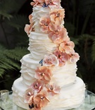Cascading Flower Cake
Photography: Chrisman Studios
Read More:
http://www.insideweddings.com/weddings/gorgeous-alfresco-garden-wedding-in-bel-air-california/436/ Ruffled wedding cake with sugar flowers and butterflies