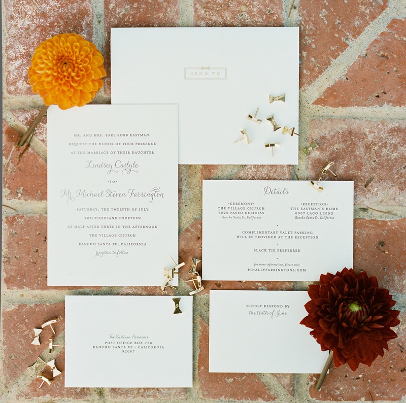 Very Simple Wedding Invitation Suite
Photography: Ryan Ray Photography
Read More:
http://www.insideweddings.com/weddings/outdoor-wedding-with-vibrant-pink-orange-decor-in-california/723/ Simple white wedding invitations with wedding information and gold bow pins