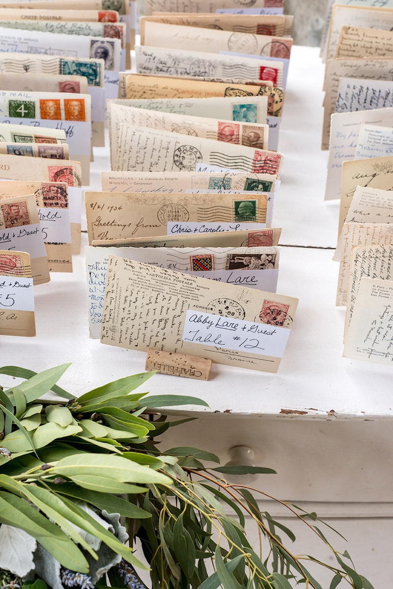 Postcard Place Cards
Photography: Stacy Newgent
Read More:
http://www.insideweddings.com/weddings/rustic-barn-wedding-tented-reception-on-family-farm-in-ohio/690/ Rustic tented reception with Italian postcards used as place cards on wine corks, white dresser