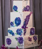 Painted Floral Cake
Photography: Kesha Lambert Photography
Read More:
http://www.insideweddings.com/weddings/romantic-wedding-with-vibrant-purple-decor-and-caribbean-traditions/1138/ wedding cake with white square tiers painted with blue and purple flowers