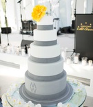Five-Layer White and Grey Cake
Photography: Ira Lippke Studios
Read More:
http://www.insideweddings.com/weddings/contemporary-backyard-white-wedding-under-clear-tent-in-chicago/857/ White and grey fondant cake with yellow flower cake topper orchid table display cake table