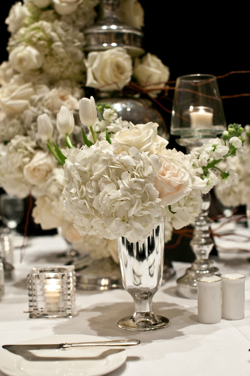 Silver Centerpiece Arrangement
Photography: Collins Metu Photography
Read More:
http://www.insideweddings.com/weddings/sarita-minor-and-jarett-dillard/432/ White reception table with small centerpiece in silver vase
