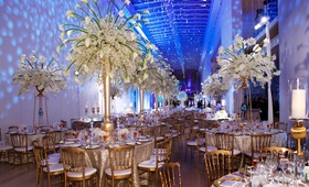 Centerpieces
Photography: Bob %26 Dawn Davis Photography
Read More:
http://www.insideweddings.com/weddings/a-dream-winter-wedding-at-the-art-institute-of-chicago/563/ Wedding reception tables with tall gold trumpet vases and white flowers