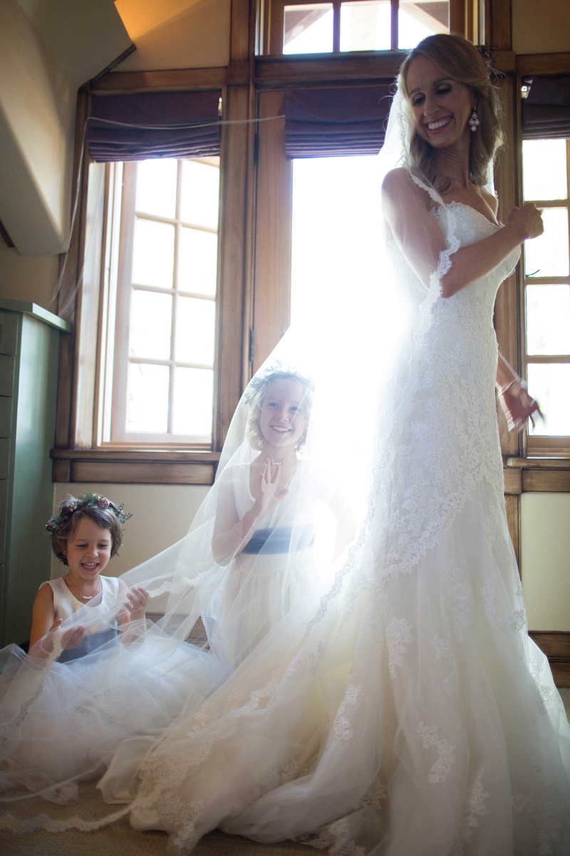 Flower Girls Play Under Bride's Veil
Photography: Sallee Photography
Read More:
http://www.insideweddings.com/weddings/rustic-chic-lakeside-wedding-with-geometric-details-in-california/843/ flower girls play under brides veil bride smiling flower crowns sash dresses