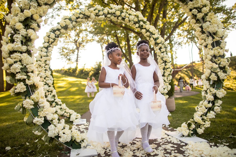 Flower Girls Walking Through Floral Arches
Photography: Brian Bossany Photography
Read More:
http://www.insideweddings.com/weddings/luxurious-heaven-inspired-royal-wedding-celebration-in-minneapolis/1333/ outdoor wedding ceremony ghana african royalty ivory hydrangea greenery circle arch outdoor ceremony
