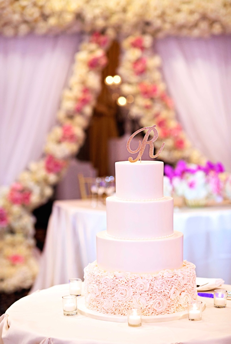 Monogram Topper on Wedding Cake
Photography: Carasco Photography
Read More:
http://www.insideweddings.com/weddings/new-york-yankees-infielder-marries-in-opulent-chicago-soiree/764/ four-tier wedding cake with rose frosted details on base, glitter gold monogram cake topper
