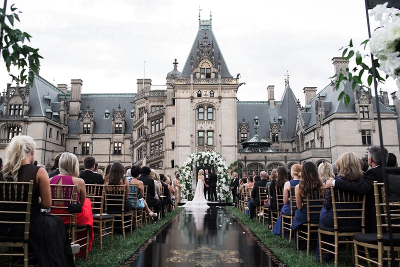 Bride %26 Groom at End of Black Aisle
Photography: Parker J Pfister Photographer
Read More:
http://www.insideweddings.com/weddings/gorgeous-alfresco-ceremony-tented-reception-at-a-luxurious-estate/1044/ Wedding ceremony at the Biltmore Estate in Asheville, North Carolina black aisle runner gold crest