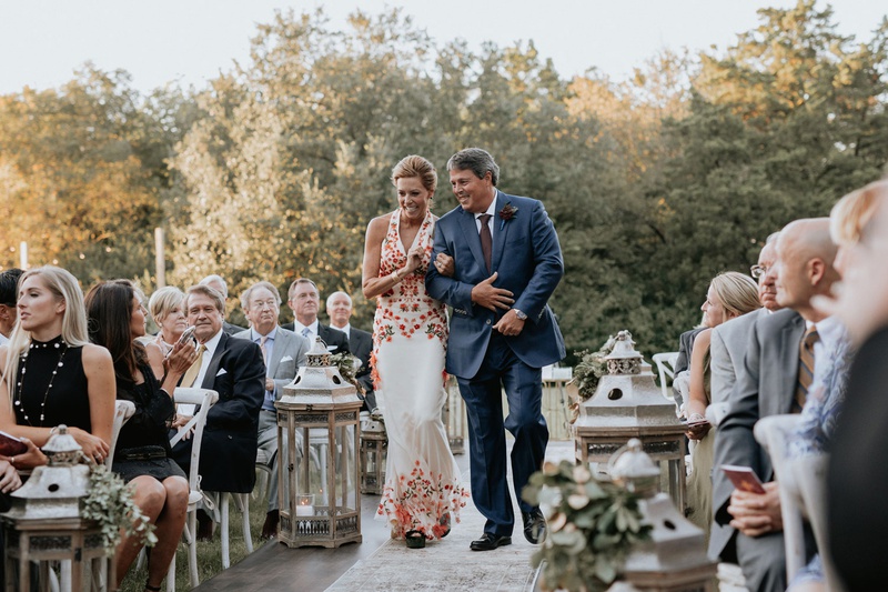 Mother of Bride in Colorful Gown
Photography: Grant Daniels Photography
Read More:
http://www.insideweddings.com/weddings/outdoor-ceremony-tented-reception-with-cozy-fall-color-palette/1183/ mother of bride in halter neck dress pink red flowers embroidery rustic boho wedding lanterns