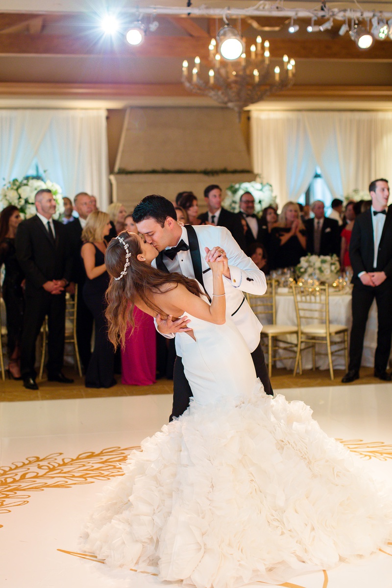 Kiss During First Dance
Photography: Chard Photo
Read More:
http://www.insideweddings.com/weddings/alfresco-ceremony-on-the-coast-classic-ballroom-reception/1290/ bride in sparkling headband, ines di santo dress, groom in white tux jacket, kiss on dance floor