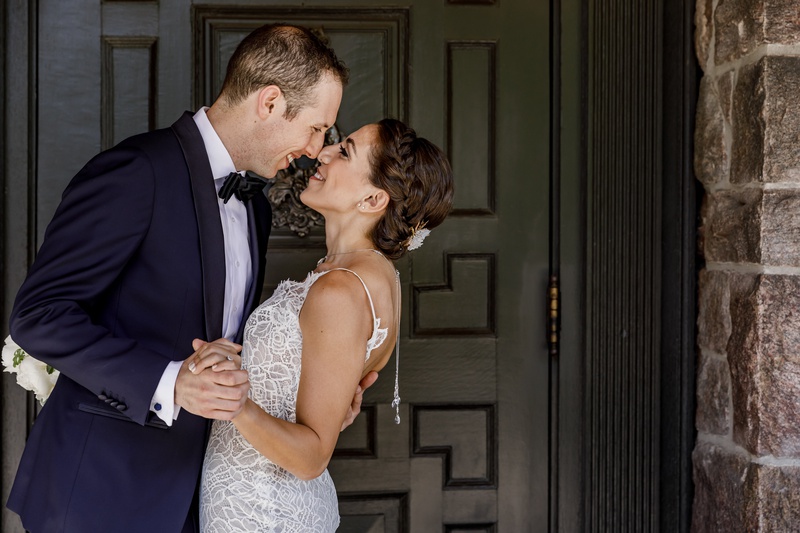 Bride and Groom Embrace in Doorway
Photography: Amy Anaiz Photography
Read More:
http://www.insideweddings.com/weddings/lakeside-wedding-with-blue-details-in-upstate-new-york/1140/ bride in custom hayley paige wedding dress and back necklace, groom in navy tuxedo