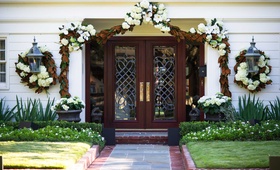 Southern At-Home Wedding Entrance
Photography: Chris Bailey Photography
Read More:
http://www.insideweddings.com/weddings/southern-at-home-wedding-inspired-by-father-of-the-bride-in-texas/753/ Private manor residence wedding venue with white flower and magnolia leaf garland decorations