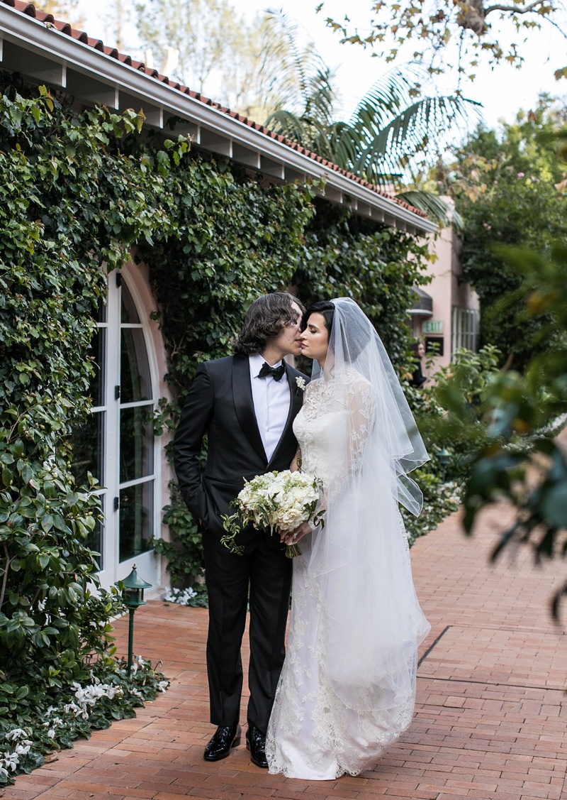 Bride %26 Groom at Bel-Air Venue
Photography: Samuel Lippke Studios
Read More:
http://www.insideweddings.com/weddings/glamorous-alfresco-ceremony-ballroom-reception-and-after-party/1041/ Wedding portrait bride in veil and long sleeve wedding dress groom tuxedo bow tie kisses cheek