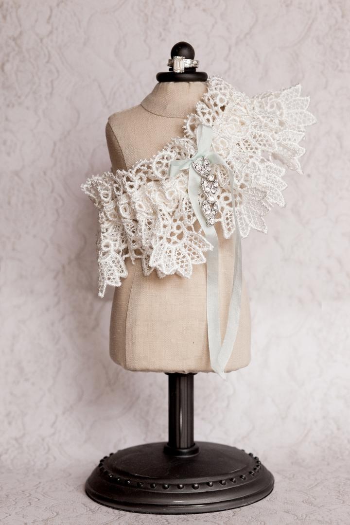 Lace Leg Garter
Photography: Jana Williams Photography
Read More:
http://www.insideweddings.com/weddings/ivory-gold-blush-lakefront-new-hampshire-wedding/412/ Wedding day garter on mini dress stand with light blue ribbon