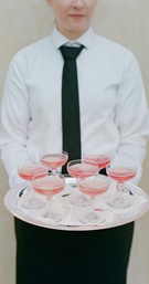 Pink Wedding Cocktails
Photography: Elizabeth Messina
Read More:
http://www.insideweddings.com/weddings/ethereal-garden-inspired-morning-ceremony-alfresco-brunch/582/ Server holding silver tray of coupe champagne glasses with pink drink