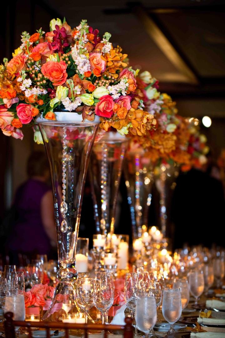 Vibrant Floral Centerpieces
Photography: Vallentyne Photography
Read More:
http://www.insideweddings.com/weddings/spring-wedding-at-the-lodge-at-torrey-pines/388/ Transparent vases topped with orange flowers