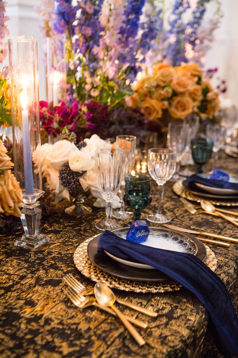 Periwinkle Candle with Vibrant Florals
Photography: Duke Photography
Read More:
http://www.insideweddings.com/weddings/dramatic-tablescape-at-launch-party-for-luxe-linens-newest-line/987/ wedding styled shoot, periwinkle tapered candles, bright flowers teal glassware, black & gold linens
