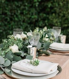 Elegant Place Setting for Garden Reception
Photography: Lucas Rossi and Michelle Kyle
Read More:
http://www.insideweddings.com/weddings/inspirational-outdoor-garden-wedding-shoot-with-modern-elements/687/ Garden wedding reception table with greenery runner, white roses, golden tablecloth, charger