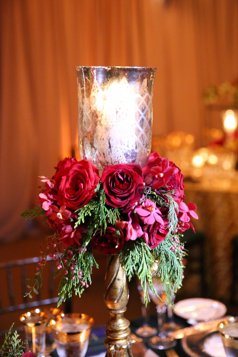 Gold Candle Stand with Red Roses
Photography: Robyn Rachel Photography
Read More:
http://www.insideweddings.com/weddings/christmas-theme-wedding-with-festive-red-green-decor-in-illinois/729/ Gold candlestick with votive, red roses, greenery on reception table