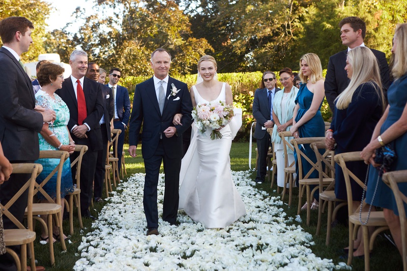 Bride with Father on Flower Petal Aisle
Photography: Christian Oth Studio
Read More:
http://www.insideweddings.com/weddings/timeless-wedding-with-garden-inspired-decor-in-the-hamptons/1237/ bride in classic wedding dress with pink dahlia bouquet father of bride white flowers on grass